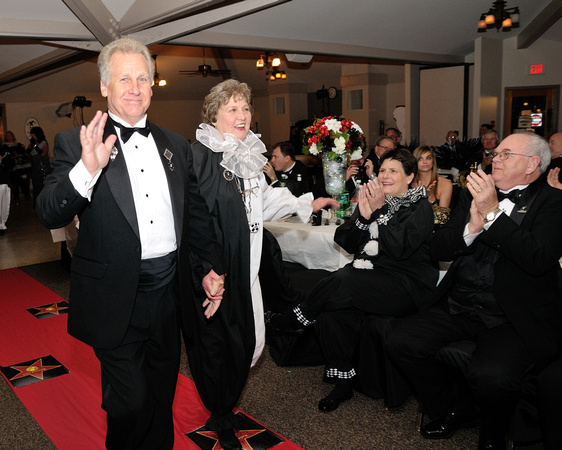 2011 King Warren Culbertson and 2011 Queen Mary Ann Strength enter the ball room.