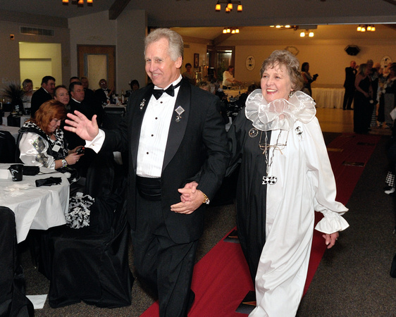 2011 King Warren Culbertson and 2011 Queen Mary Ann Strength enter the ball room.